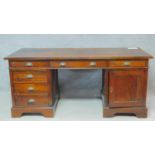 An Eastern teak three part pedestal desk fitted with a cupboard and drawers on bracket feet. H.78