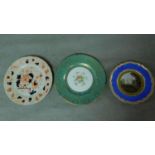 Three hand painted antique porcelain plates. One with a blue border and gilt sunflower detailing