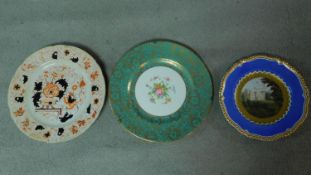 Three hand painted antique porcelain plates. One with a blue border and gilt sunflower detailing