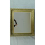 A rectangular wall mirror in gilt foliate frame. 79x69cm