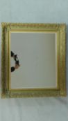 A rectangular wall mirror in gilt foliate frame. 79x69cm