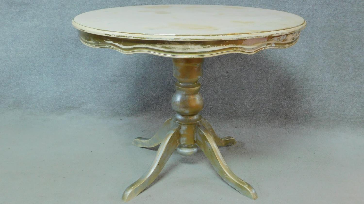 A Victorian style distressed painted dining table on cabriole supports. H.77 W.100 D.100cm