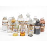 A collection of fourteen 19th century clear pharmacy/chemist jars each with a gilt-bordered red /