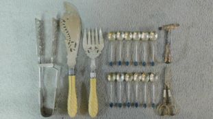 A collection of silver plated cutlery. Including a set of carved twist ivory handled fish servers, a
