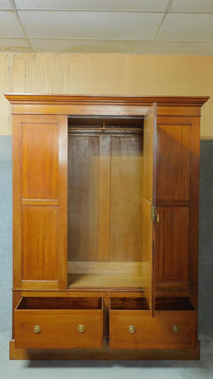 An early 20th century mahogany and satinwood inlaid wardrobe with central panel door fitted with - Image 2 of 5