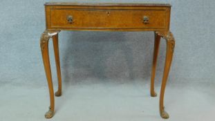 A mid century carved burr walnut early Georgian style hall table fitted with frieze drawer on