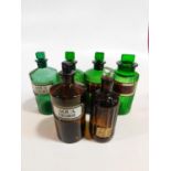 A collection of 19th century four green and two brown pharmacy jars and bottles some with a gilt-