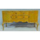 A mid century Georgian style burr walnut sideboard on carved cabriole supports. H.92 W.161 D.58cm