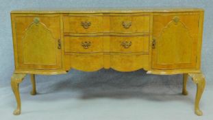 A mid century Georgian style burr walnut sideboard on carved cabriole supports. H.92 W.161 D.58cm