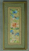 A framed and glazed antique Chinese silk embroidery with brocade border and a butterfly and flower