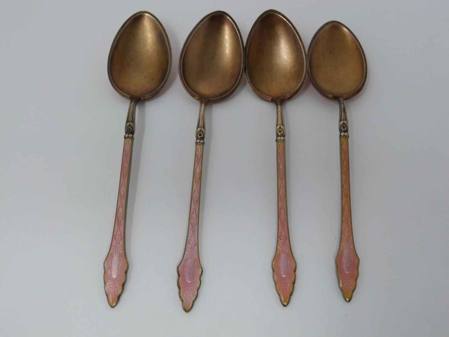 A collection of ten silver tea spoons. A set of four Norwegian gilded pink guilloche enamel coffee - Image 2 of 15