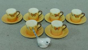 A hand painted Collingwood porcelain coffee set decorated with various butterflies along with a