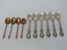 A collection of ten silver tea spoons. A set of four Norwegian gilded pink guilloche enamel coffee