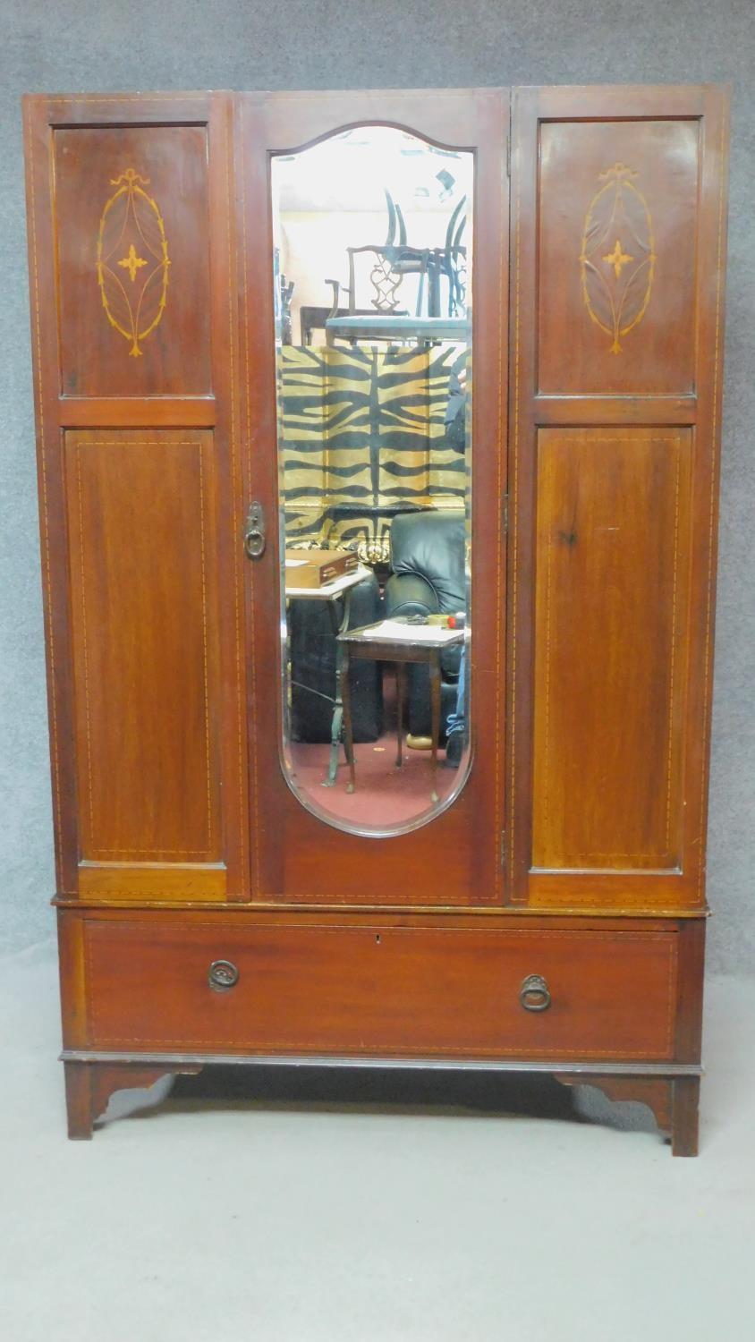 An Edwardian mahogany and satinwood inlaid wardrobe. H.187 W.117 D.45cm