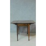 A 19th century mahogany drop flap Pembroke table on square tapering supports with spade feet. H.67