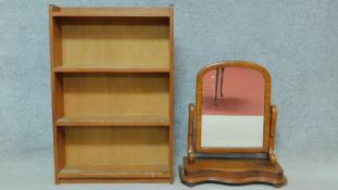 A mid 20th century teak open bookcase and a Victorian mahogany swing toilet mirror. H.91 W.61 D.18cm