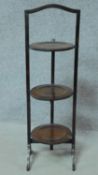 An Edwardian mahogany folding three tier cakestand. H.85cm