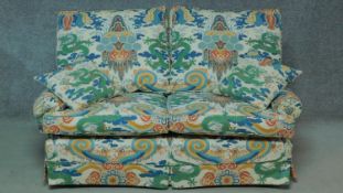 A two seater sofa in polychrome Chinese style upholstery. H.85 W.160 D.90cm