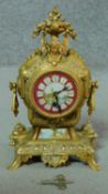 A French style brass cased mantel clock with painted face. (with pendulum and key). H.29cm