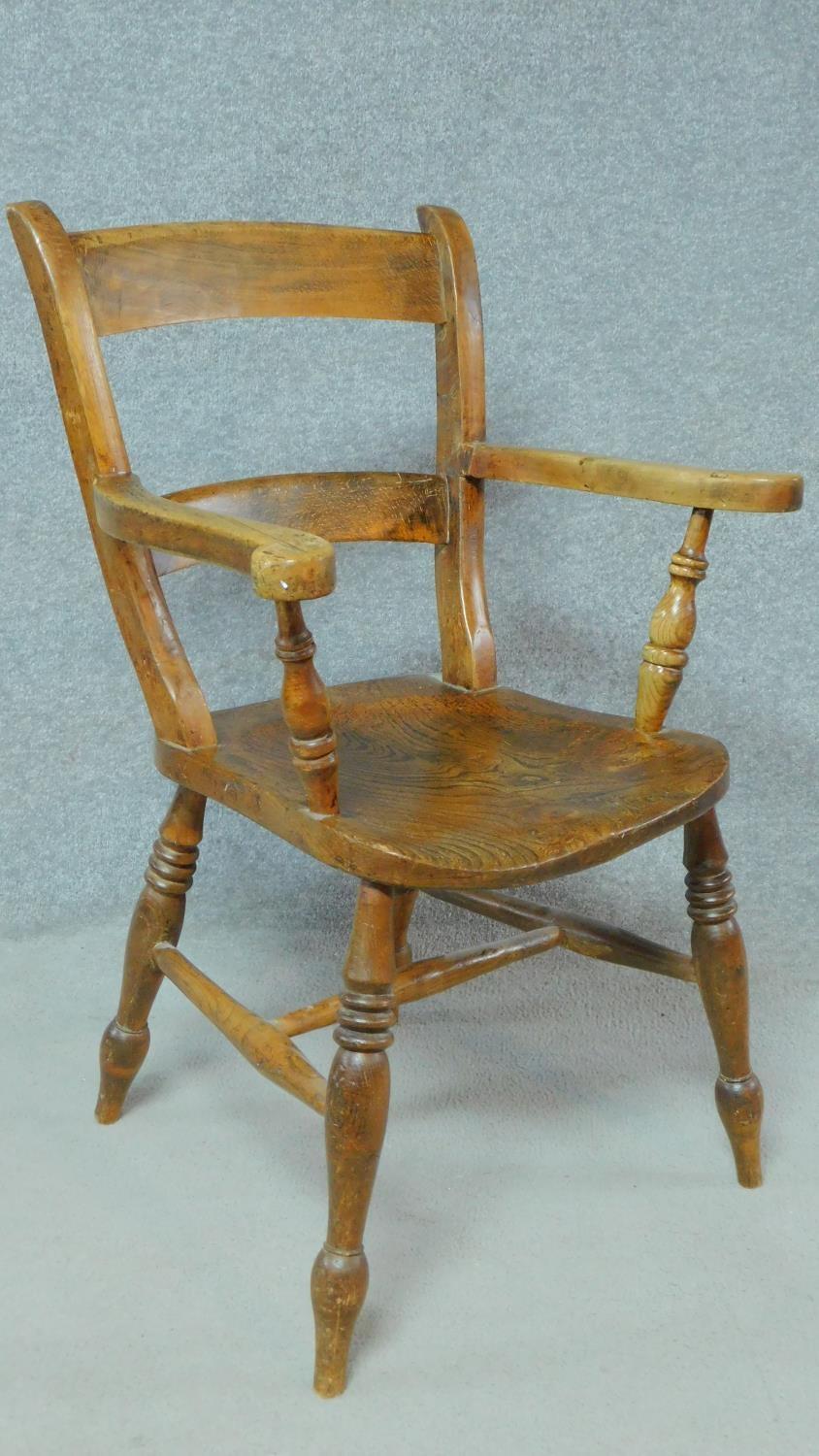 A 19th century country style open armchair with elm seat on turned stretchered supports. H.89cm - Image 2 of 4