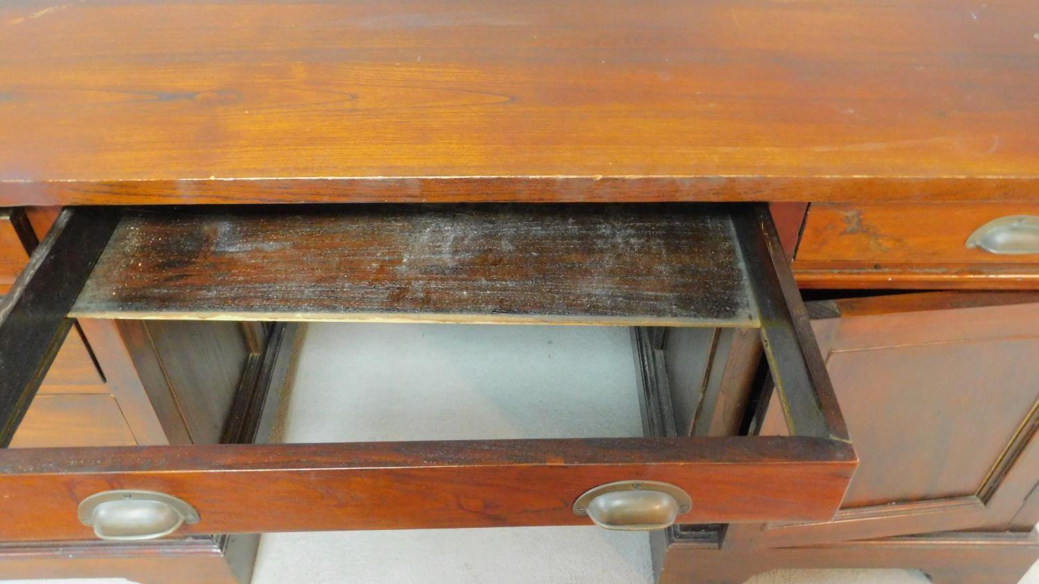 An Eastern teak three part pedestal desk fitted with a cupboard and drawers on bracket feet. H.78 - Image 4 of 5