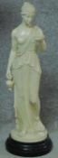 A moulded figure of a Roman goddess on a circular stepped ebonised socle. H.68cm