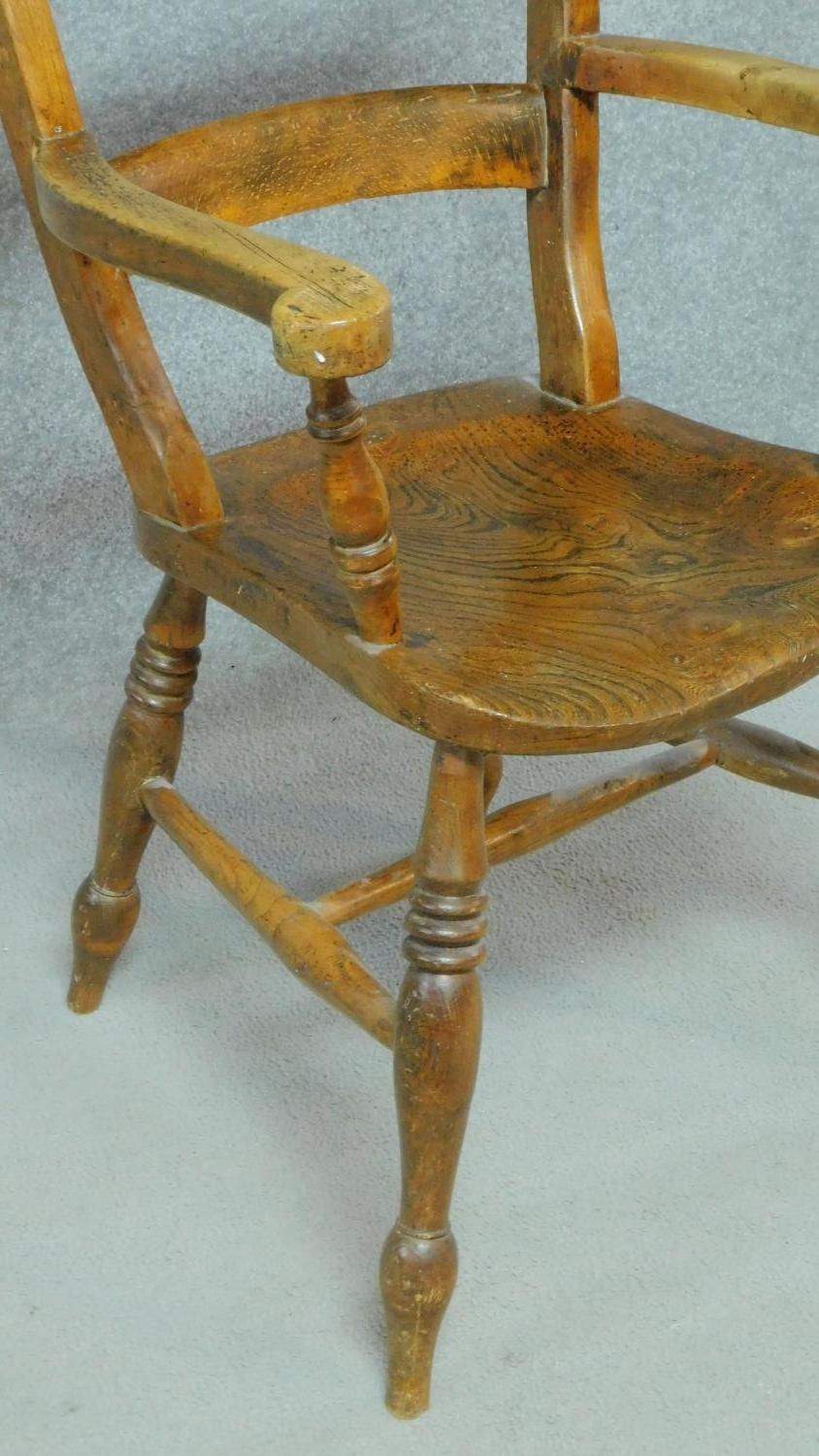 A 19th century country style open armchair with elm seat on turned stretchered supports. H.89cm - Image 4 of 4