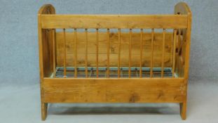 A European country style pitch pine cot with carved panels and hinged side. H.99 W.126 D.66cm