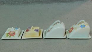 A collection of four Art Deco hand painted Radford Pottery lidded butter and cheese dishes. Each