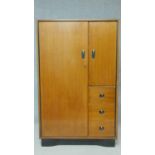 A mid century teak small compactum wardrobe by Beautility fitted with drawers, shelves and hanging