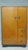 A mid century teak small compactum wardrobe by Beautility fitted with drawers, shelves and hanging