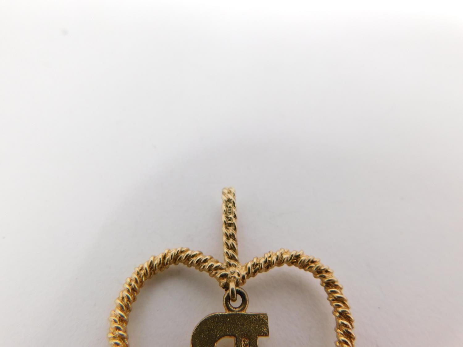 A 9carat gold chain with yellow metal dice charm and three 9 carat gold pendants. One pendant - Image 8 of 11