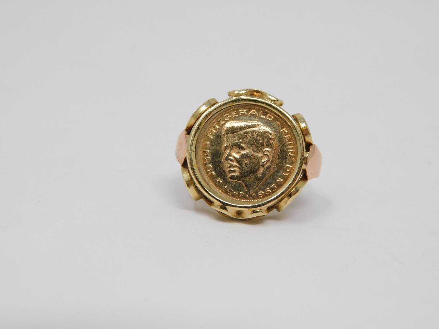 A yellow and pink metal Kennedy commemorative coin ring. 1963, double eagle to the back. Set in a