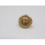 A yellow and pink metal Kennedy commemorative coin ring. 1963, double eagle to the back. Set in a