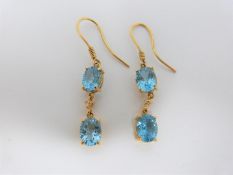 Bespoke 18 carat yellow gold, diamond and blue Topaz drop earrings. Each earring set with two oval