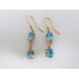 Bespoke 18 carat yellow gold, diamond and blue Topaz drop earrings. Each earring set with two oval