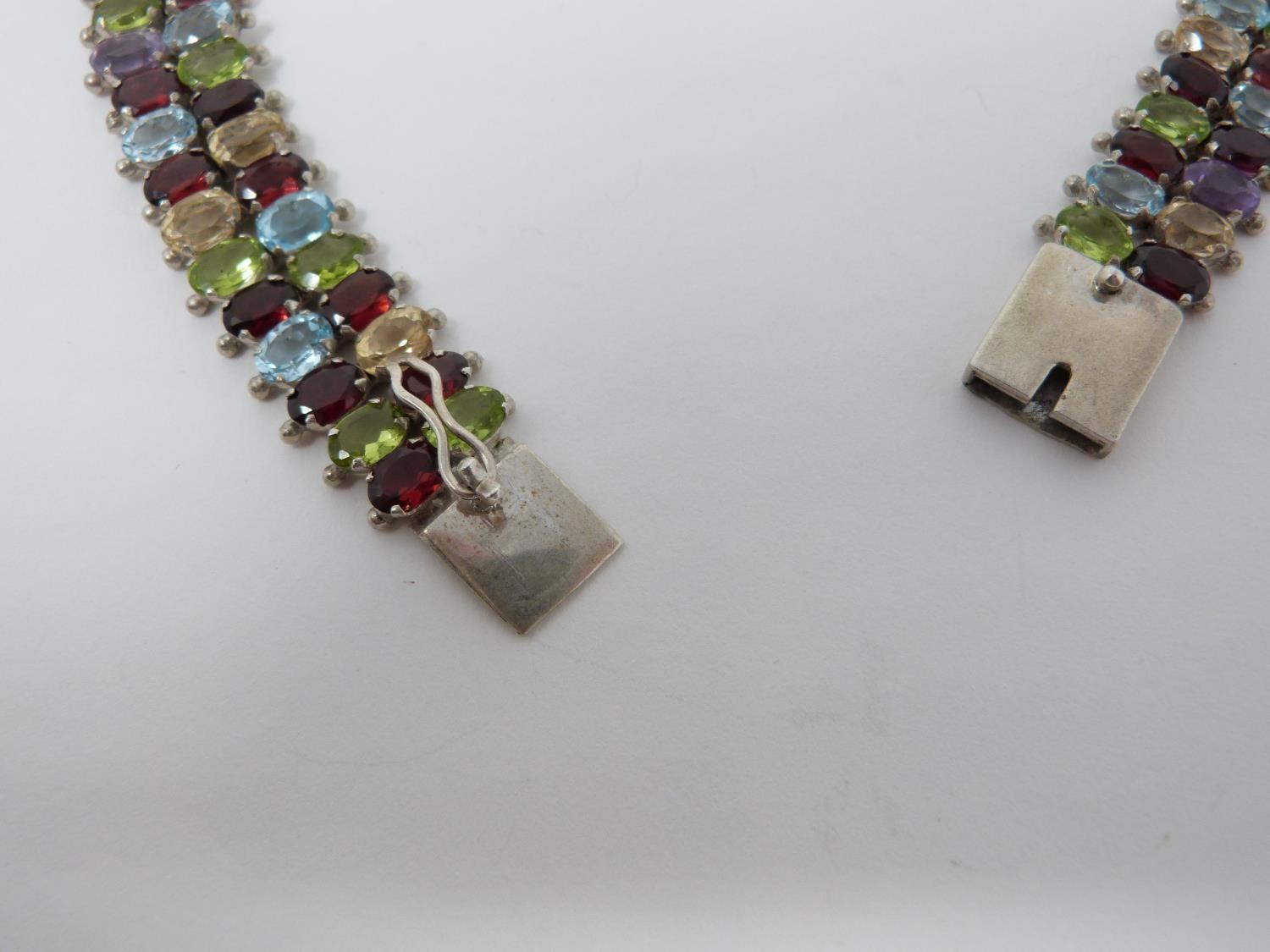 A bespoke silver and multi gemstone collar necklace, set with fifty two oval mixed cut Peridots, - Image 6 of 9