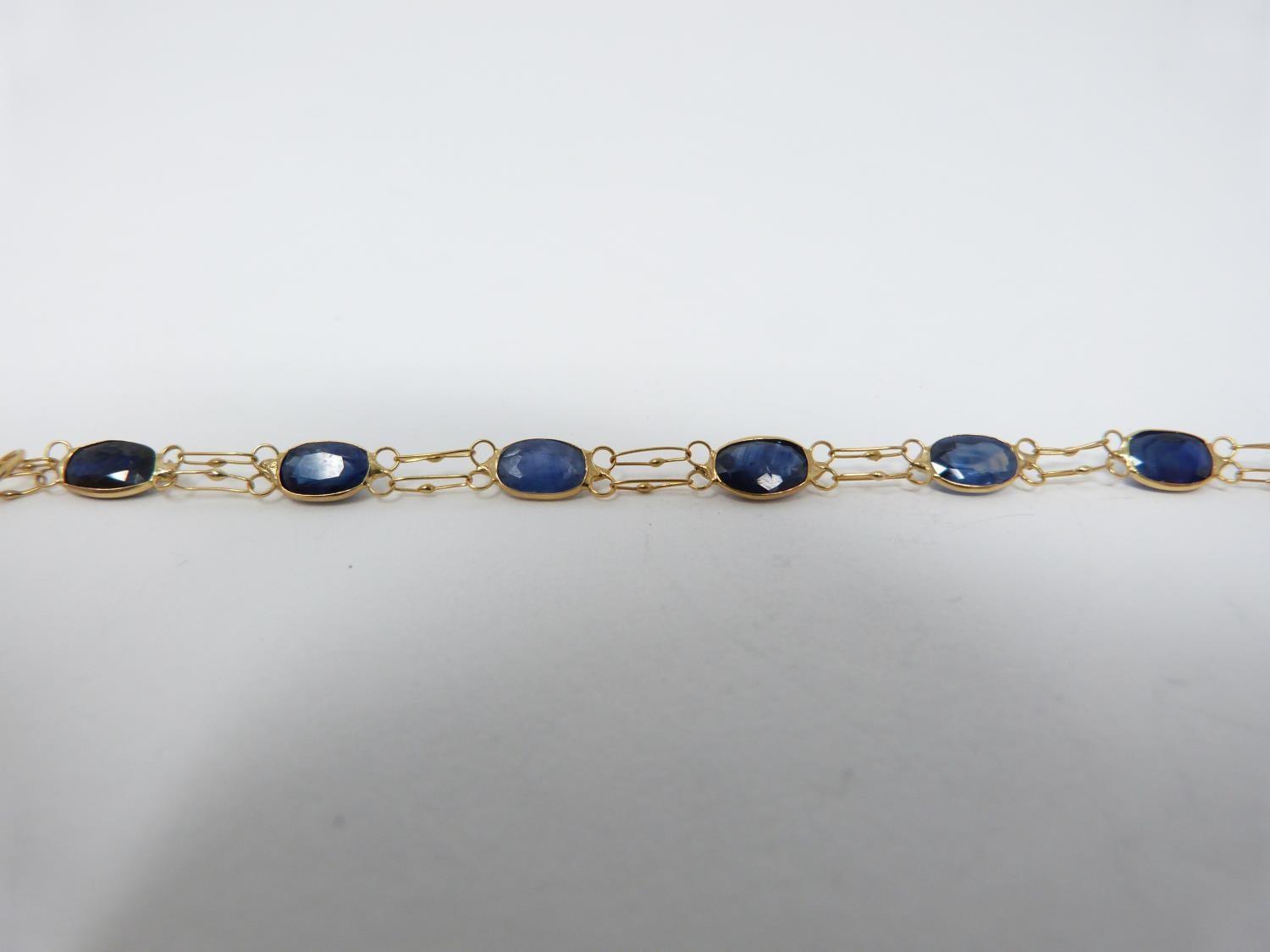 A bespoke heated ceylon sapphire and yellow metal (tested 14 carat yellow gold) chain bracelet, - Image 6 of 8