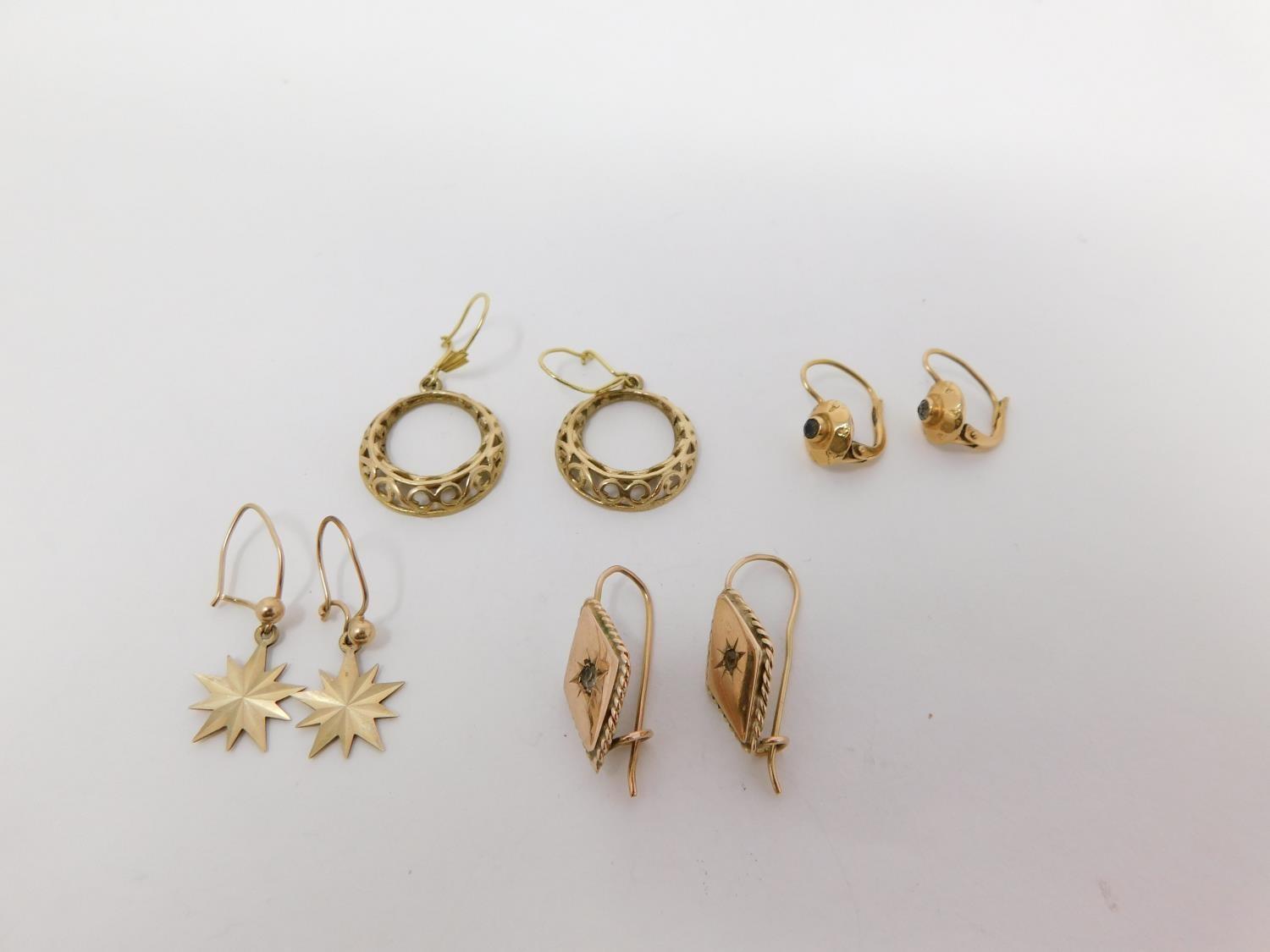 Four pairs of gold earrings. Including a pair of 18 carat gold textured gem set earrings, a pair