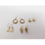 Four pairs of gold earrings. Including a pair of 18 carat gold textured gem set earrings, a pair