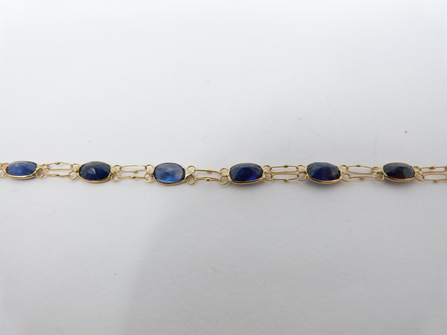 A bespoke heated ceylon sapphire and yellow metal (tested 14 carat yellow gold) chain bracelet, - Image 7 of 8