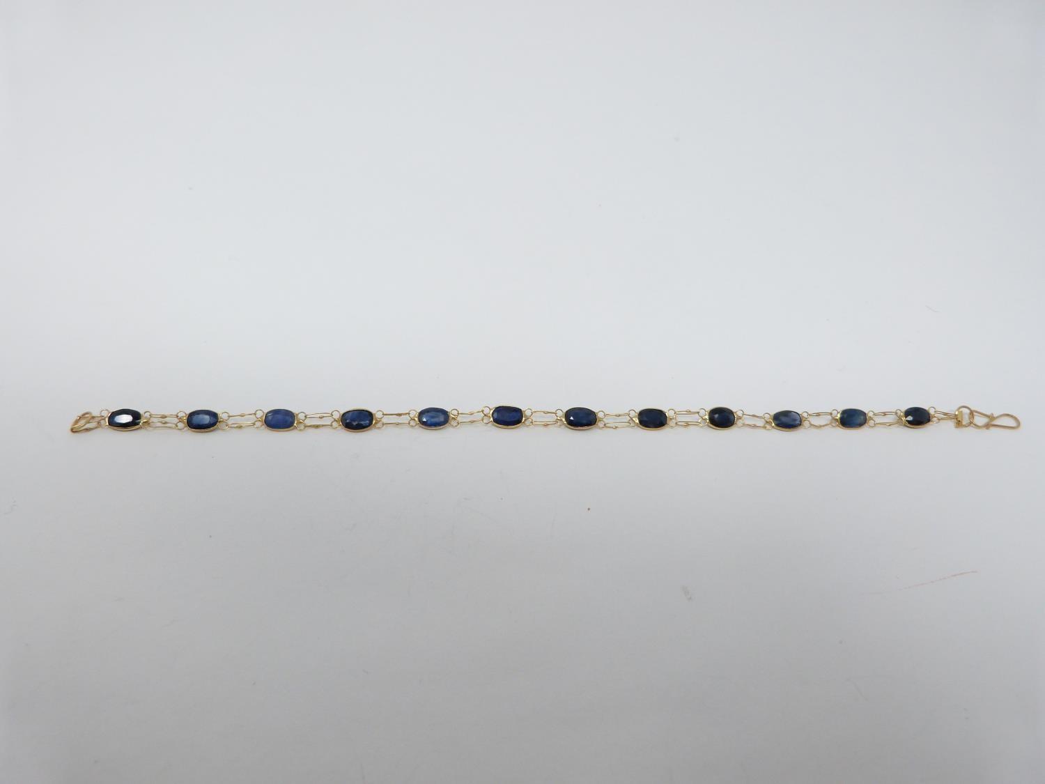 A bespoke heated ceylon sapphire and yellow metal (tested 14 carat yellow gold) chain bracelet, - Image 5 of 8