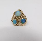 A opal cabochon and yellow metal wire dress ring. Set with three round black opal cabochons set in
