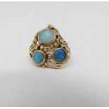 A opal cabochon and yellow metal wire dress ring. Set with three round black opal cabochons set in