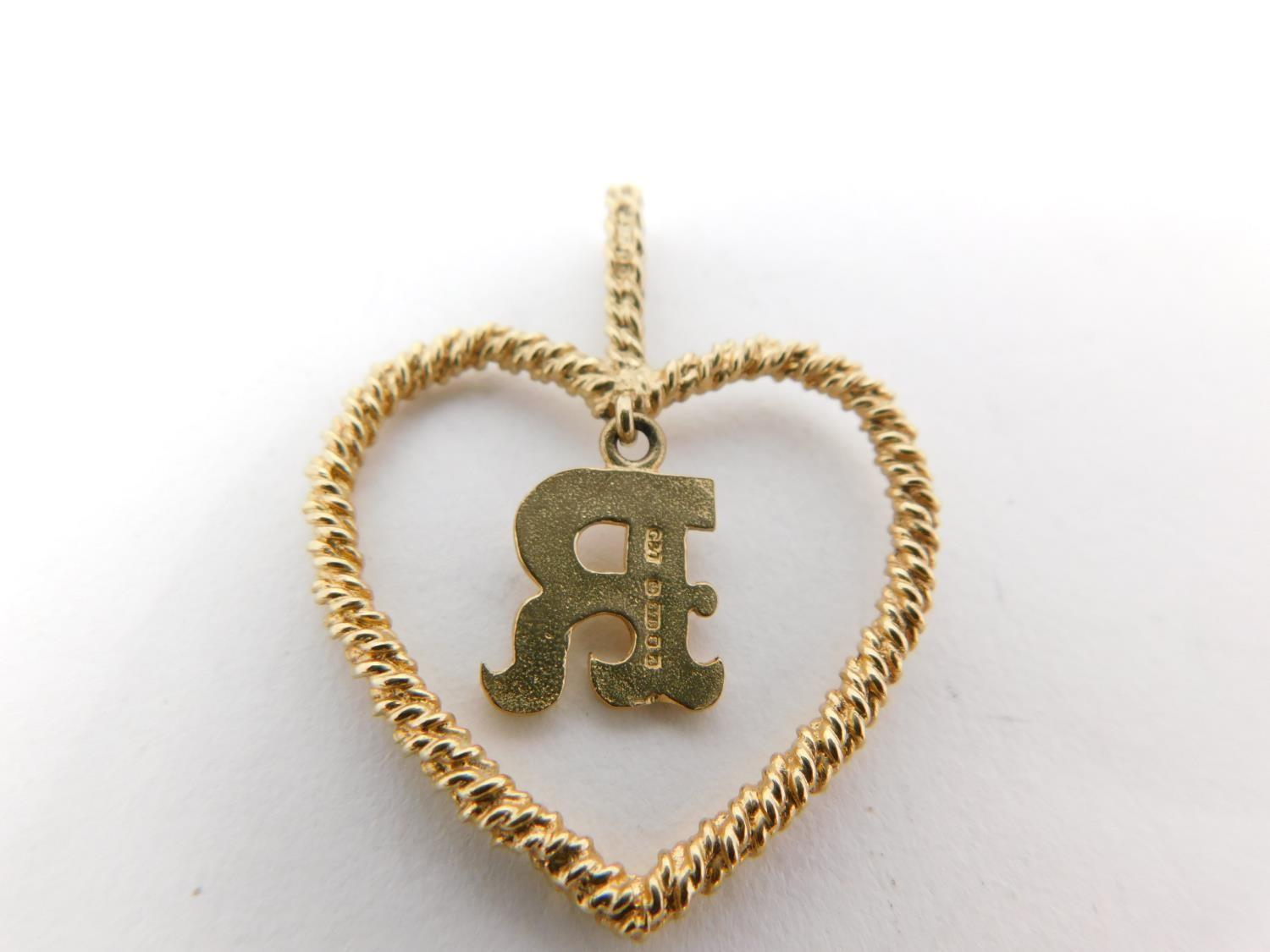 A 9carat gold chain with yellow metal dice charm and three 9 carat gold pendants. One pendant - Image 9 of 11