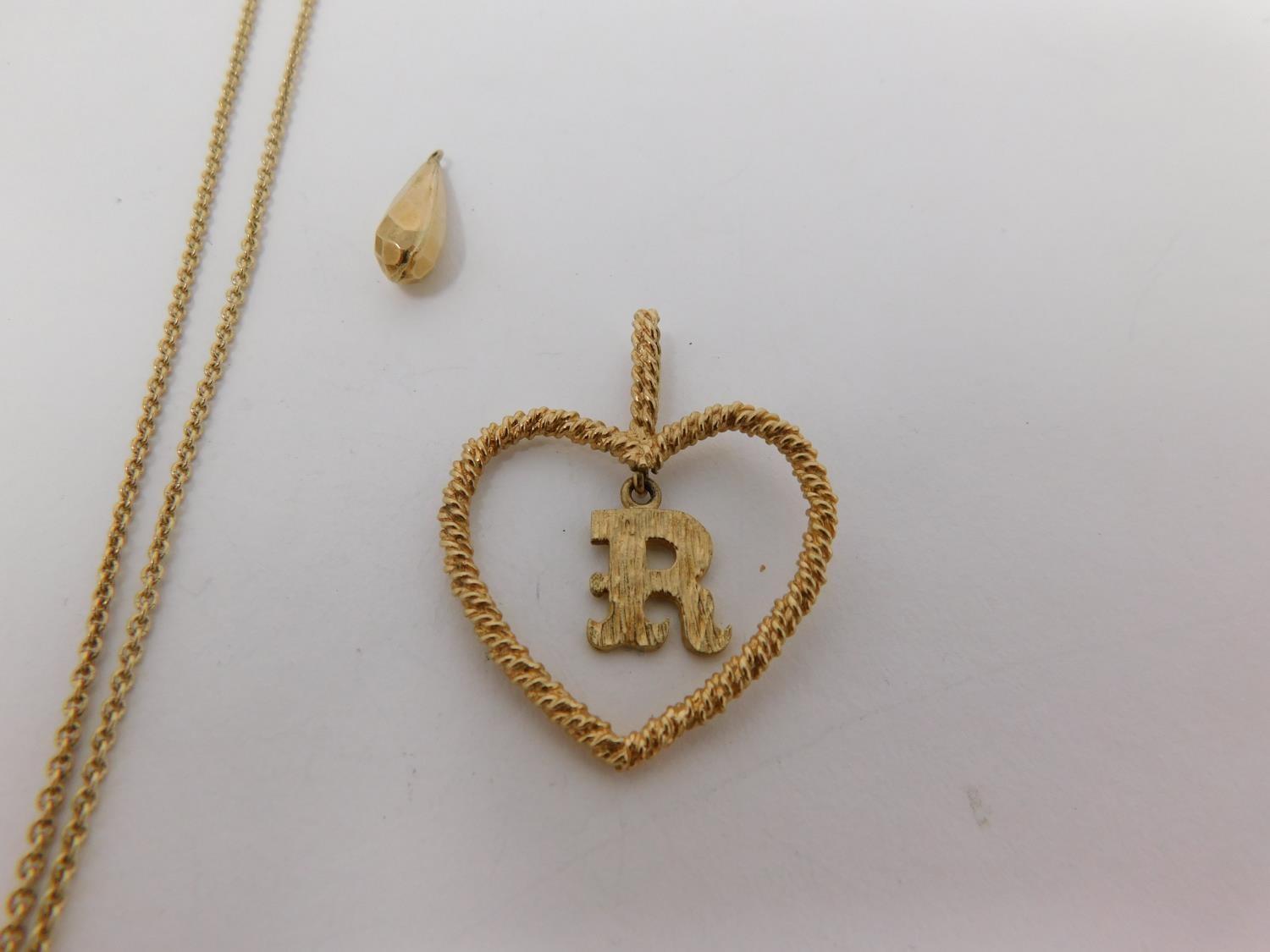 A 9carat gold chain with yellow metal dice charm and three 9 carat gold pendants. One pendant - Image 3 of 11