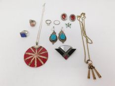 A collection of silver jewellery. Including a shell and acrylic silver pendant, an enamel and silver