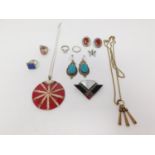 A collection of silver jewellery. Including a shell and acrylic silver pendant, an enamel and silver