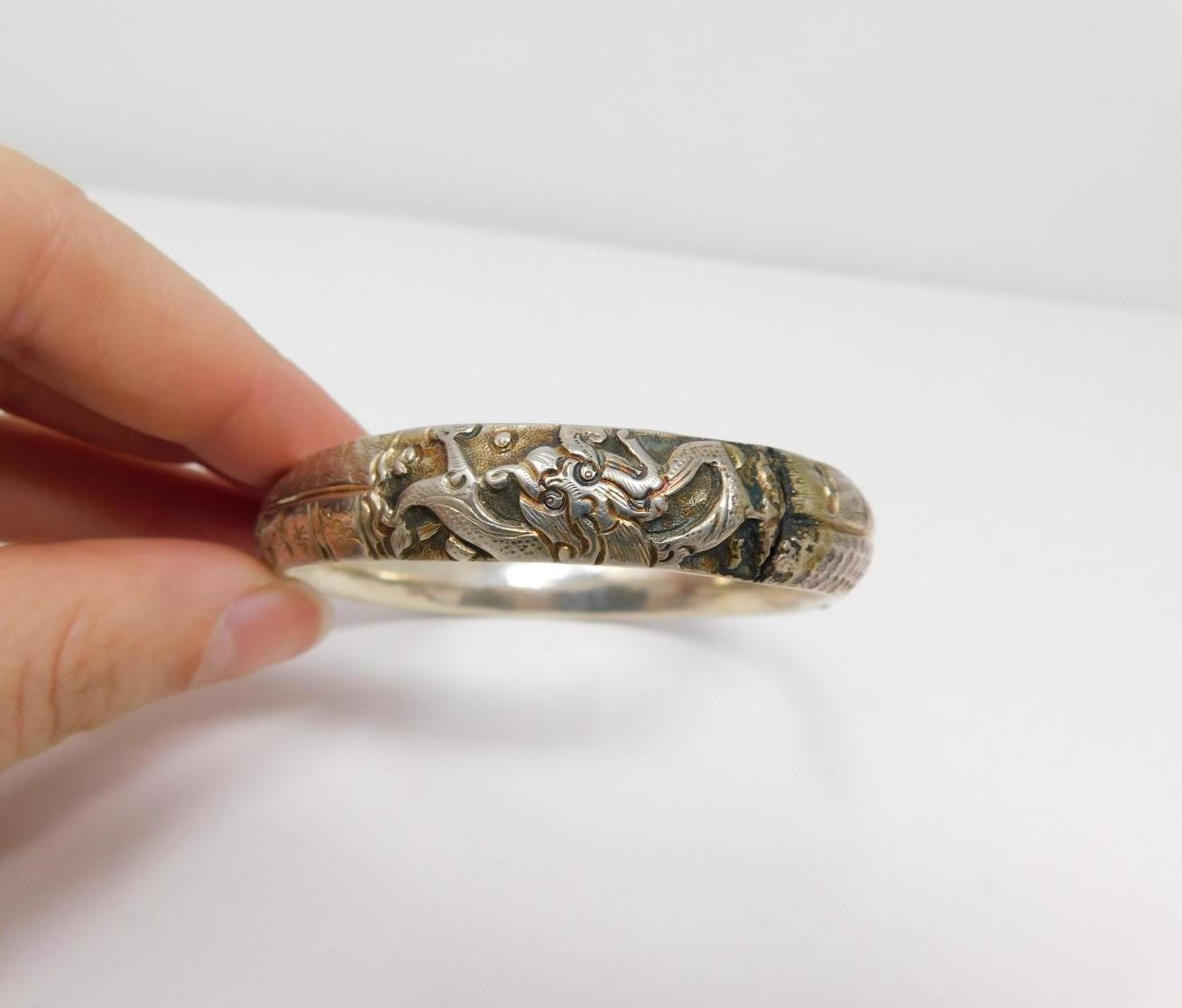 An antique Chinese engraved white metal bangle and toggle buttons. The bangle is engraved with a - Image 4 of 14