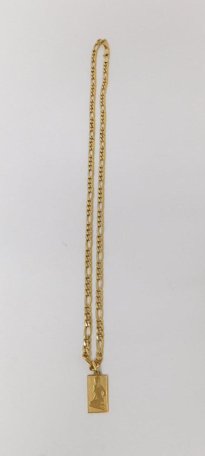 An 18 carat yellow gold Figaro chain with engraved zodiac rectangular pendant. Fastens with a secure